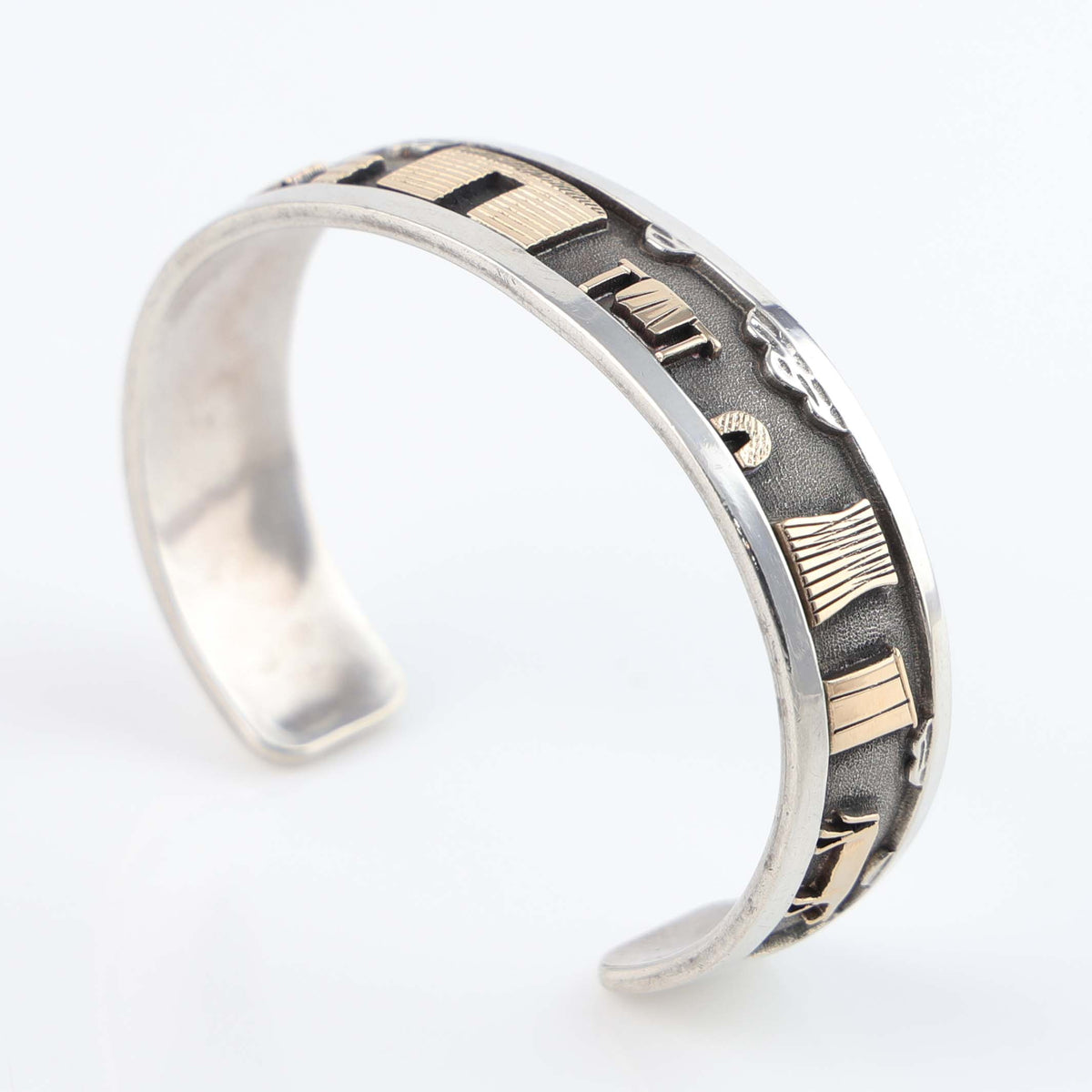 Gold on Silver Navajo Storyteller Cuff by Roland Begay