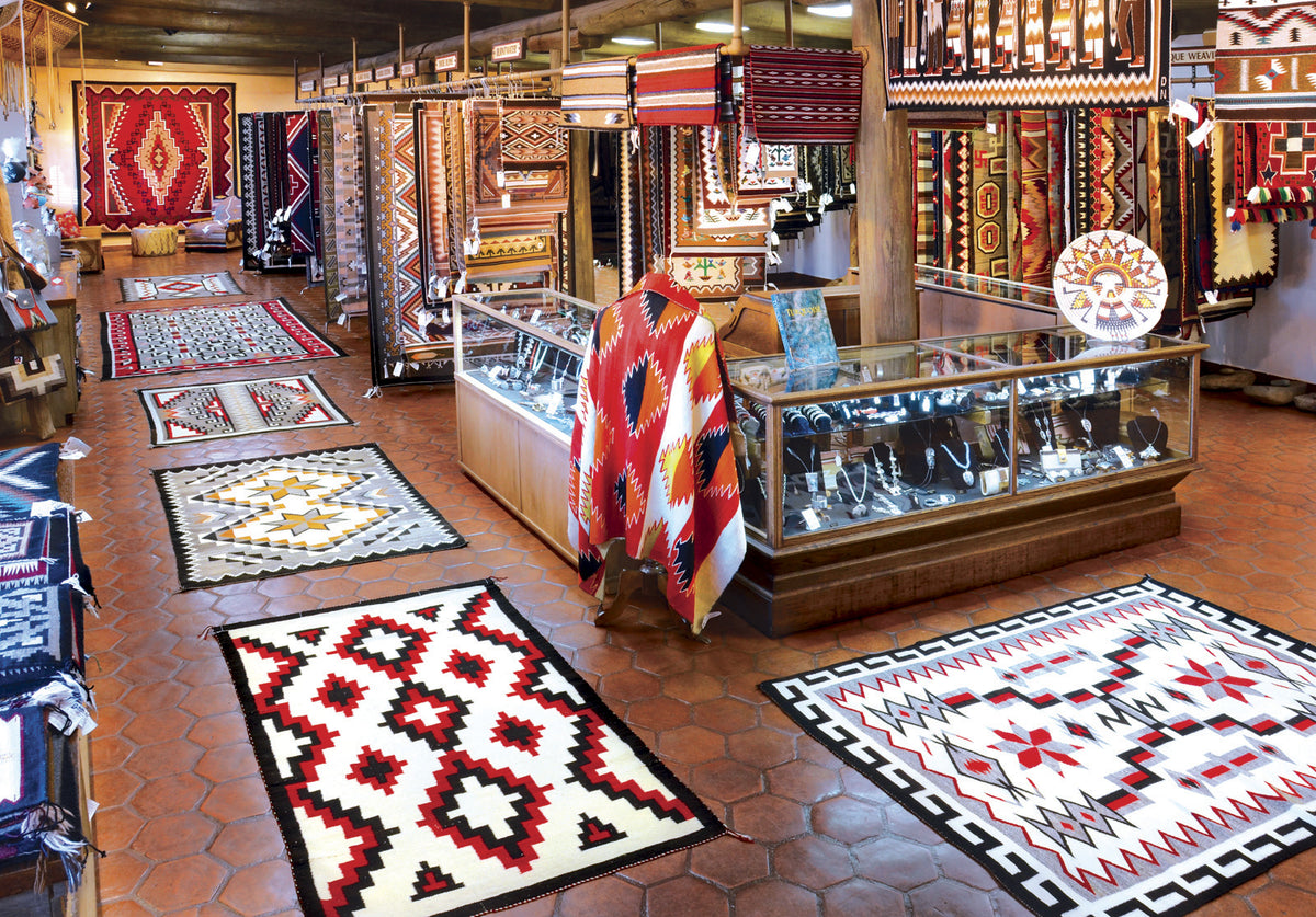 Navajo rugs on the floor and walls of the main gallery at Garland's Navajo Rugs